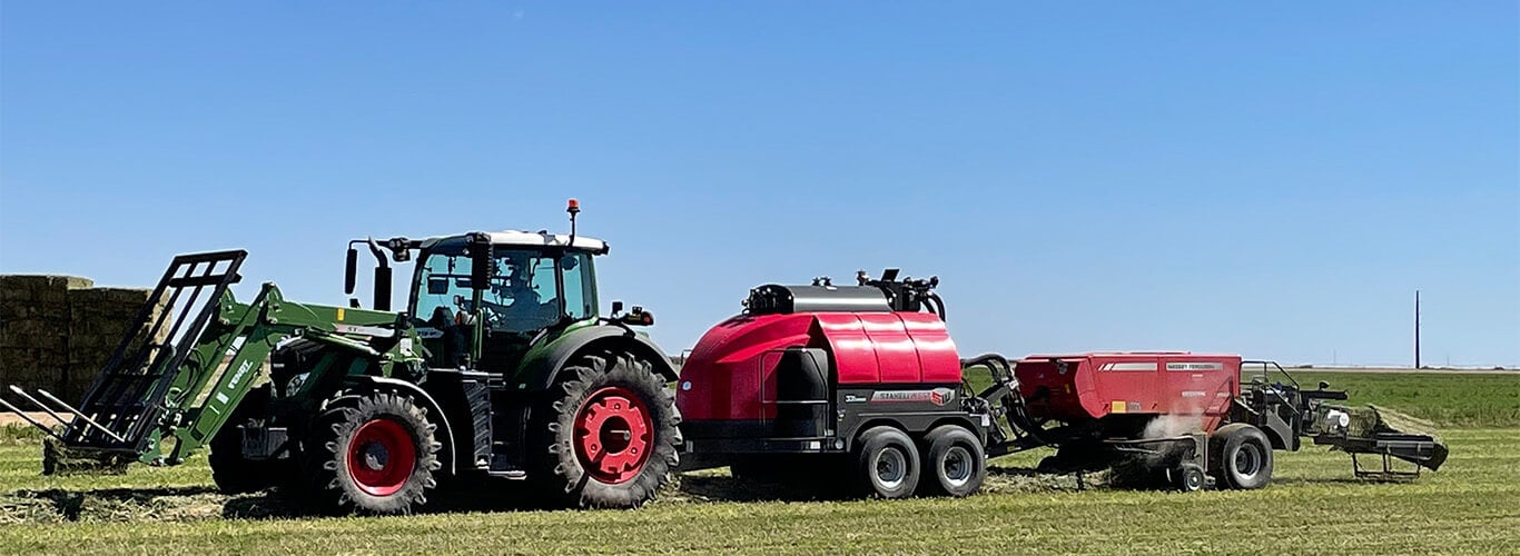 Fendt loader tractor bailing hay.