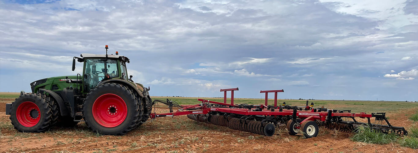 Fendt tractor pulling tilliage equipment.