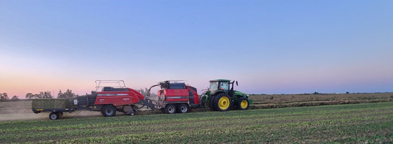 John Deere tractor pulling a steamer baler combo.