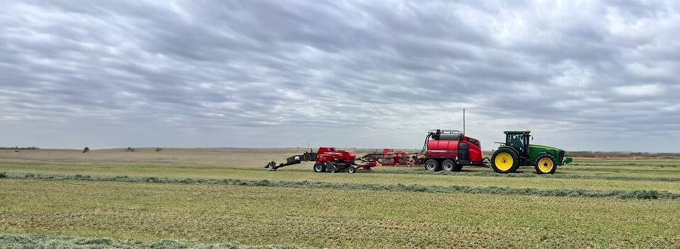Tractor baling square bales.